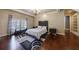 Bedroom with hardwood floors, large window with shutters, and walk-in closet at 3229 Carmichael Pl, Duluth, GA 30097