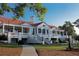 Exterior view of elegant clubhouse with a red tile roof and white siding at 3229 Carmichael Pl, Duluth, GA 30097