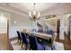 Dining area with elegant chandelier, table, and view of the staircase at 3229 Carmichael Pl, Duluth, GA 30097