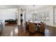 Dining room adjacent to the living area, with stylish furniture and plantation shutters at 3229 Carmichael Pl, Duluth, GA 30097