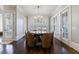 Dining room with unique round table, leather chairs, and abundant natural light at 3229 Carmichael Pl, Duluth, GA 30097
