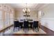 Dining room with chandelier, table, chairs, and large windows at 3229 Carmichael Pl, Duluth, GA 30097