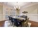 Dining room with wood table, blue and tan chairs, and arched window at 3229 Carmichael Pl, Duluth, GA 30097