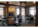 Clubhouse dining area with fireplace, wood tables, and comfortable seating at 3229 Carmichael Pl, Duluth, GA 30097