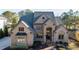 Large brick home with gray roof and arched entryway at 3229 Carmichael Pl, Duluth, GA 30097