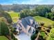 Brick home with a three-car garage, large driveway, and landscaping at 3229 Carmichael Pl, Duluth, GA 30097