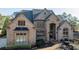 Stately brick home with arched entryway and manicured landscaping at 3229 Carmichael Pl, Duluth, GA 30097