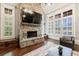 Stone fireplace with built-in shelving and large windows at 3229 Carmichael Pl, Duluth, GA 30097