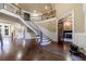 Spacious foyer with elegant curved staircase and hardwood floors at 3229 Carmichael Pl, Duluth, GA 30097