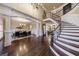 Grand foyer with elegant curved staircase, hardwood floors, and view of the dining room at 3229 Carmichael Pl, Duluth, GA 30097