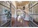 Grand foyer with curved staircase, hardwood floors, and chandelier at 3229 Carmichael Pl, Duluth, GA 30097