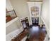 Grand foyer with elegant staircase, hardwood floors, and a stunning chandelier at 3229 Carmichael Pl, Duluth, GA 30097