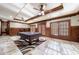 Game room with pool table, wood-paneled walls, and ample natural light at 3229 Carmichael Pl, Duluth, GA 30097