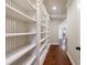 Hallway with built-in white bookshelves and hardwood flooring at 3229 Carmichael Pl, Duluth, GA 30097