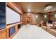 Home theater room featuring a large projector screen, brown leather seats, and wood accents at 3229 Carmichael Pl, Duluth, GA 30097