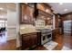 Chef's kitchen with Wolf range, custom hood, and decorative tile backsplash at 3229 Carmichael Pl, Duluth, GA 30097