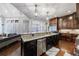 Kitchen island with sink, dishwasher, and granite countertop at 3229 Carmichael Pl, Duluth, GA 30097