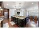 Gourmet kitchen with large island, dark cabinets, and stainless steel appliances at 3229 Carmichael Pl, Duluth, GA 30097