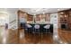 Kitchen with dark wood cabinets, stainless steel appliances, and a large island at 3229 Carmichael Pl, Duluth, GA 30097