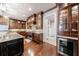 Open concept kitchen with wood cabinetry, stainless steel appliances, and a wine fridge at 3229 Carmichael Pl, Duluth, GA 30097