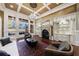 Living room with large windows, fireplace, decorative shelving, and plush seating at 3229 Carmichael Pl, Duluth, GA 30097