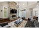 Living room featuring a stone fireplace, high ceilings, and abundant natural light at 3229 Carmichael Pl, Duluth, GA 30097