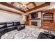 Basement living room featuring a fireplace, entertainment center, and leather couch at 3229 Carmichael Pl, Duluth, GA 30097