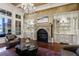 Elegant living room with fireplace, custom built-ins, and large windows at 3229 Carmichael Pl, Duluth, GA 30097