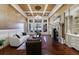 Living room with fireplace, built-in shelves, and large windows overlooking the outdoors at 3229 Carmichael Pl, Duluth, GA 30097