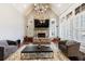 Living room with a stone fireplace, vaulted ceilings, and ample seating at 3229 Carmichael Pl, Duluth, GA 30097