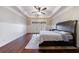 Spacious main bedroom with hardwood floors, ceiling fan, and large windows at 3229 Carmichael Pl, Duluth, GA 30097