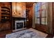 Elegant home office with fireplace, built-in bookshelves, and large window at 3229 Carmichael Pl, Duluth, GA 30097