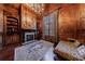 Home office with fireplace, bookshelves, day bed, and wood-paneled walls at 3229 Carmichael Pl, Duluth, GA 30097
