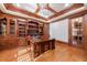 Home office with built-in bookshelves, hardwood floors, and coffered ceiling at 3229 Carmichael Pl, Duluth, GA 30097
