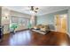 Spacious office/den with lots of windows, hardwood floors, yellow chairs and large TV at 3229 Carmichael Pl, Duluth, GA 30097