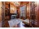 Wood-paneled office/study with fireplace, built-in shelves, and hardwood floors at 3229 Carmichael Pl, Duluth, GA 30097