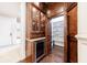 Hidden pantry behind custom wood cabinetry, with a wine fridge at 3229 Carmichael Pl, Duluth, GA 30097