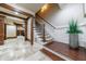 Stairway with dark wood steps and white wainscoting at 3229 Carmichael Pl, Duluth, GA 30097
