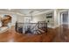 Curved upstairs hallway with hardwood floors, iron railing, and decorative table at 3229 Carmichael Pl, Duluth, GA 30097