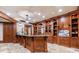 Spacious wet bar in basement with custom cabinetry and granite countertop at 3229 Carmichael Pl, Duluth, GA 30097