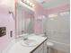 Pink bathroom with single vanity and shower/tub combo at 290 Sable Cir, Covington, GA 30016