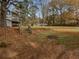 Large, fenced backyard with a shed and wooden stairs leading to a grassy area at 30 N Cleveland Church Rd, Mcdonough, GA 30253