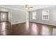 Living room with dark wood floors, ceiling fan, and lots of natural light at 231 Cambridge Dr, Loganville, GA 30052