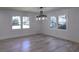 Bright, airy dining room with hardwood floors and windows offering a view of the trees at 2515 Stonington Rd, Dunwoody, GA 30338