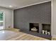 A modern gray brick fireplace is the focal point of this living room at 2515 Stonington Rd, Dunwoody, GA 30338