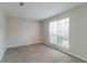 Spacious carpeted bedroom with large window and neutral walls at 2720 Thornbury Way, Atlanta, GA 30349