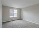 Bright bedroom with a window and neutral-toned carpet at 2720 Thornbury Way, Atlanta, GA 30349