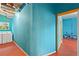 Basement laundry room with washer/dryer, teal walls, and red flooring at 680 Horsley Mill Rd, Carrollton, GA 30116