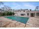 Covered pool in the backyard of a white, two-story home at 5995 Riverside Dr, Atlanta, GA 30328