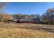 Expansive backyard with red brick ranch home, carport, and mature trees at 8450 Union Grove Rd, Lithonia, GA 30058